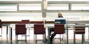 A modern, bright public library space with older adults actively engaging in learning and social activities.