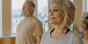 An older adult practicing gentle seated neck exercises for improved mobility.