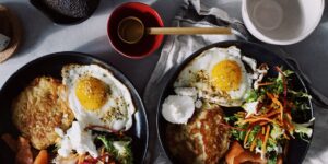 A balanced meal featuring eggs, salmon, and vegetables as sources of choline.