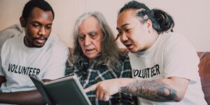 A diverse group of older adults sharing history and photographs in a community setting.