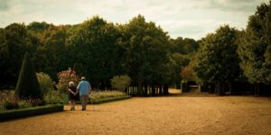 An elderly couple enjoying a stroll through an accessible botanical garden.
