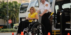 A senior traveler receiving professional wheelchair assistance at a modern airport.