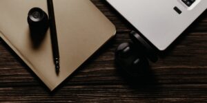 A serene writing setup with a notebook and fountain pen on a wooden desk.