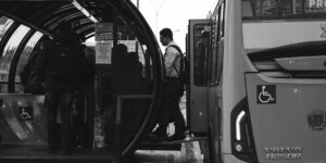 Older adults boarding an accessible electric bus in a modern city.