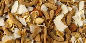 A healthy assortment of manganese-rich whole foods including grains, nuts, and greens arranged on a table.