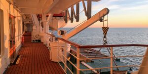 A scenic, accessible cruise ship deck at sunset with clear pathways.