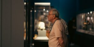 A senior traveler exploring a museum with light, minimalist gear.