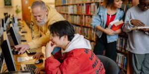 A diverse group of seniors gathered in a library setting for a poetry workshop.