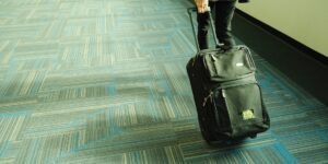 A travel suitcase and comfortable walking gear prepared for a trip.