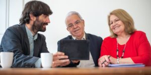 A senior couple interacting with a smart voice assistant in a sunlit living room.