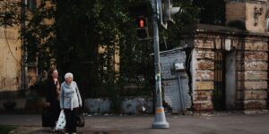Modern urban intersection with accessible pedestrian signals for senior safety.