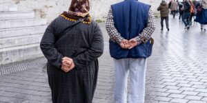 An elderly couple exploring a historic, accessible cathedral.