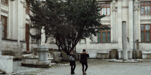 An elderly couple walking through an accessible historic plaza.