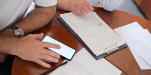 A senior couple reviewing smart home energy data on a tablet in a comfortable living room.