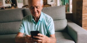 A senior adult practicing good seated posture in a comfortable home environment.