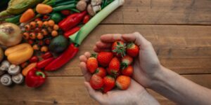 A diverse selection of plant-based foods rich in molybdenum placed on a wooden table.