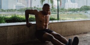 An active senior preparing for a seated tricep dip in a well-lit living room.