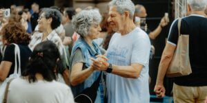 A group of older adults gathering in a community space for a literary discussion.