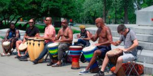 A diverse group of active seniors enjoying a rhythmic drumming circle session.