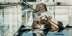 A senior adult practicing good seated posture in a comfortable home setting.