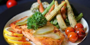 A healthy, balanced meal featuring salmon and vegetables to represent vitamin-rich nutrition for seniors.
