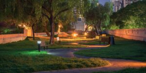 A scenic view of a well-lit park path at twilight, designed for safe evening walking for all ages.