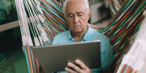 A senior adult using a digital tablet at home