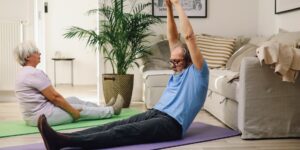 An active senior practicing gentle seated spinal extension exercises in a sunlit room.