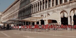 A sunlit historic plaza cafe terrace designed with accessible features.