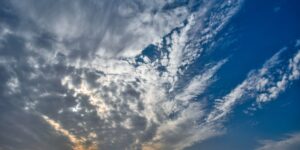A wide view of a dramatic, beautiful sky viewed from a peaceful outdoor setting.