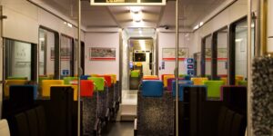 A scenic view from inside a modern, comfortable train carriage.