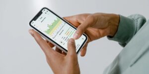 An older adult reviewing health information on a smart display in a modern, comfortable home.