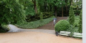 A modern, accessible city park designed for seniors with ample shade and flat paths.