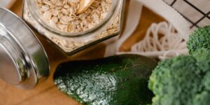 A selection of chromium-rich foods including broccoli, oats, and lean meat on a sunlit kitchen counter.