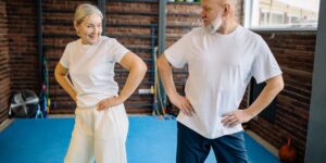 A senior adult performing seated exercises for hip stability in a bright, comfortable living space.
