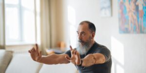 An older adult sitting with excellent posture, demonstrating core alignment.