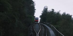 A scenic view of a modern funicular ascending a steep hill, representing accessible travel.