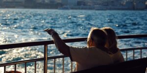 A senior couple boarding a modern ferry via an accessible ramp.