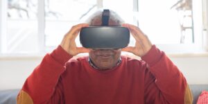 A senior person using a home VR headset in a bright living room.