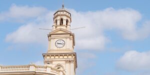 A historic clock tower featuring modern accessibility upgrades during a sunny afternoon.