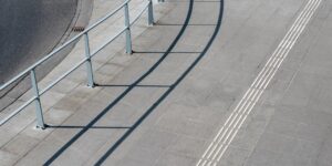 A modern, accessible city intersection featuring updated high-contrast tactile paving for pedestrian safety.