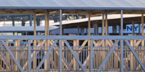 A modern, accessible riverfront ferry terminal with a wide gangway and clear, safe pathways.