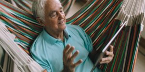 A senior person using a voice-activated smart home device for safety.