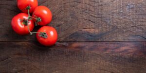 Healthy food sources of Vitamin B7 arranged on a wooden table.