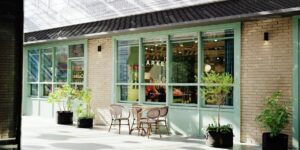 An accessible, sunlit historic courtyard cafe with level ground and comfortable seating.