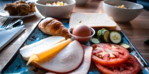 A variety of nutrient-dense whole foods including eggs, salmon, and vegetables on a kitchen table.