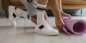 A senior person preparing to perform seated ankle exercises in a comfortable home setting.