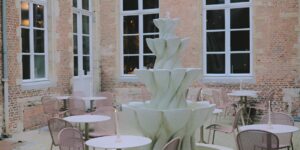 A serene, accessible historic courtyard cafe with sturdy furniture.