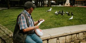 A group of active seniors enjoying bird-watching in a park.