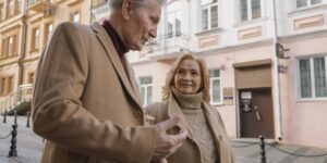 An older couple exploring a historic city street with lightweight gear.